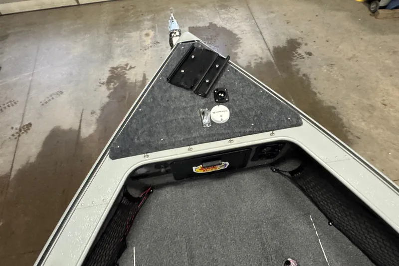 Slide: The Image of 2004 Lund 1775 Pro-V SE boat interior with carpeted deck and storage compartments. - 12
