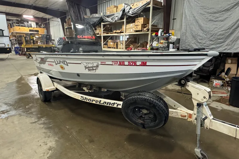Slide: The Image of 2004 Lund 1775 Pro-V SE boat on ShoreLand'r trailer in a garage setting. - 2