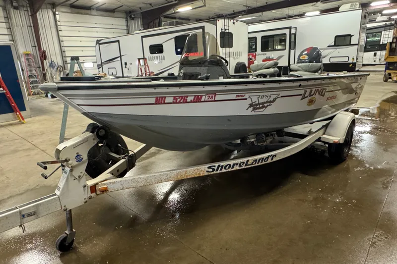 Slide: The Image of 2004 Lund 1775 Pro-V SE fishing boat on ShoreLand'r trailer in a garage. - 1