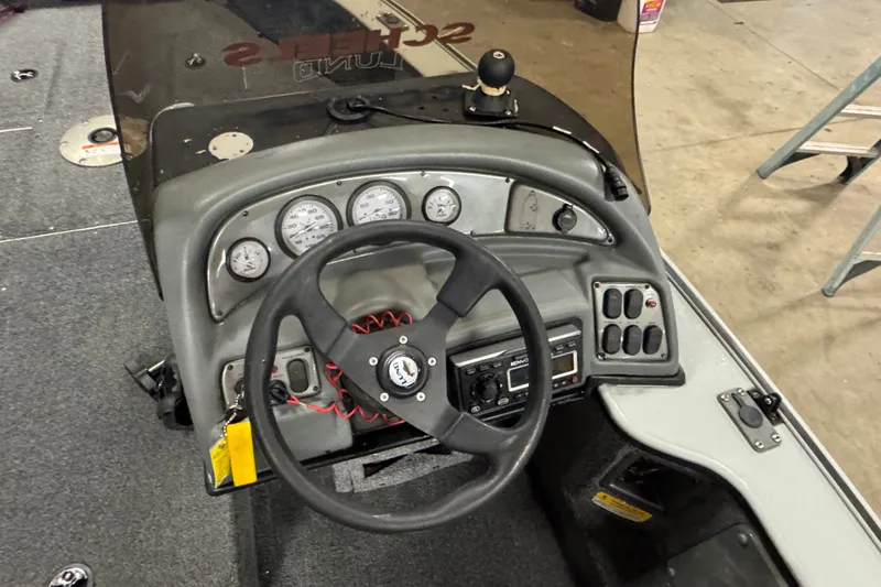 Slide: The Image of 2004 Lund 1775 Pro-V SE boat dashboard with steering wheel and instrument panel. - 6