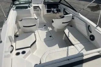 Slide: The Image of 2017 Sea Ray SPX 210 Outboard boat interior with white seating and steering console. - 8