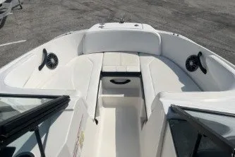 Slide: The Image of 2017 Sea Ray SPX 210 Outboard boat interior with white seating and speakers. - 10