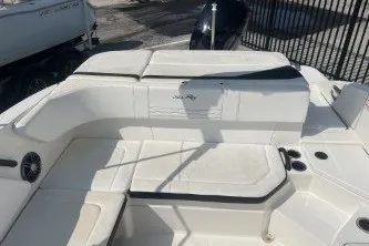 Slide: The Image of 2017 Sea Ray SPX 210 Outboard boat interior with white seating and sleek design. - 12