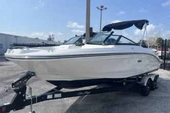 Slide: The Image of 2017 Sea Ray SPX 210 Outboard boat on trailer, parked outdoors under clear sky. - 4