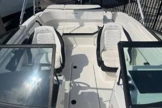 Slide: The Image of 2017 Sea Ray SPX 210 Outboard boat interior with white seating and dual consoles. - 11