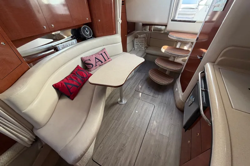 Slide: The Image of Interior of 2003 Sea Ray Sundancer 320 yacht with seating, table, and wooden steps. - 28