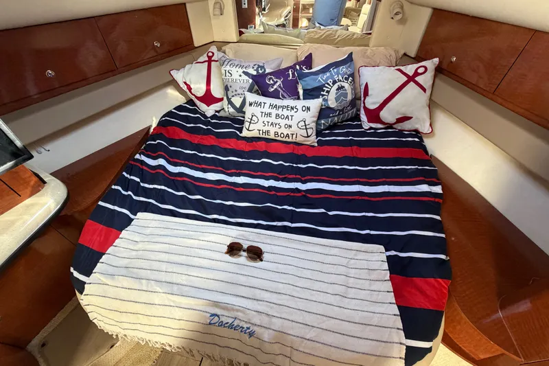 Slide: The Image of Interior of 2003 Sea Ray Sundancer 320 with nautical-themed bedding and decorative pillows. - 26
