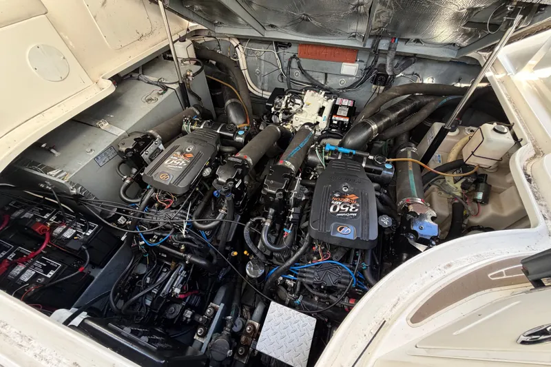 Slide: The Image of Engine compartment of a 2003 Sea Ray Sundancer 320, showcasing dual engines and wiring. - 37