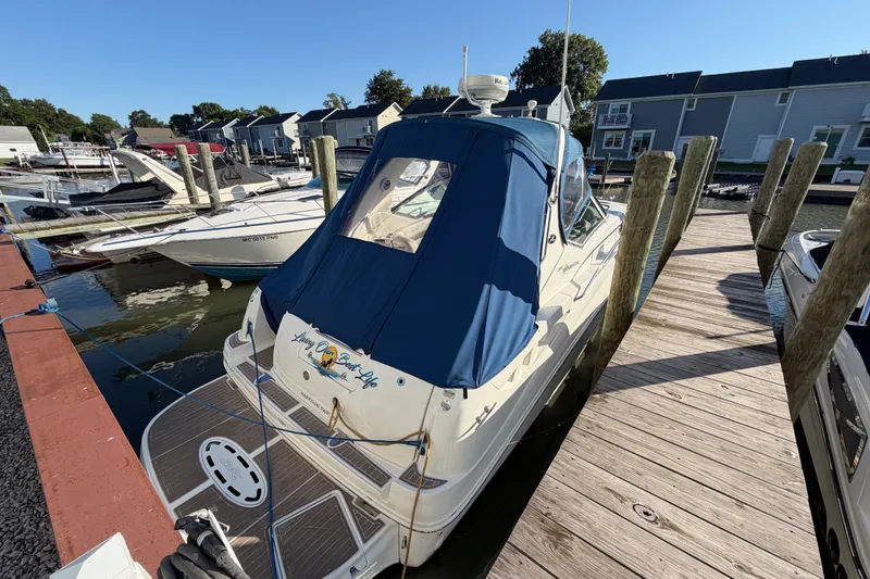 Slide: The Image of 2003 Sea Ray Sundancer 320 docked at marina with blue cover. - 3