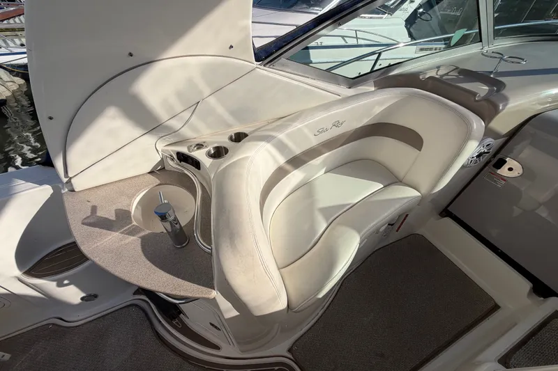Slide: The Image of 2003 Sea Ray Sundancer 320 cockpit with seating and built-in cup holders. - 10