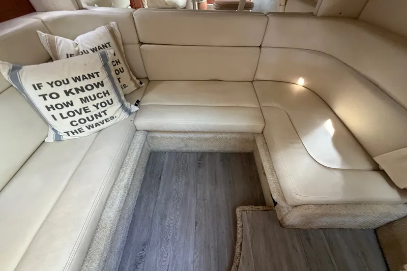 Slide: The Image of Interior of 2003 Sea Ray Sundancer 320 with beige seating and decorative pillows. - 30