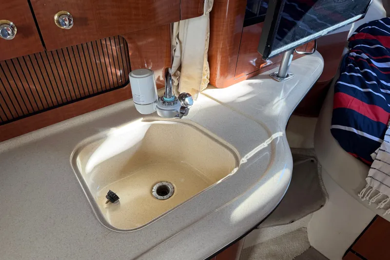 Slide: The Image of Interior of 2003 Sea Ray Sundancer 320 with sink and faucet in cabin area. - 36