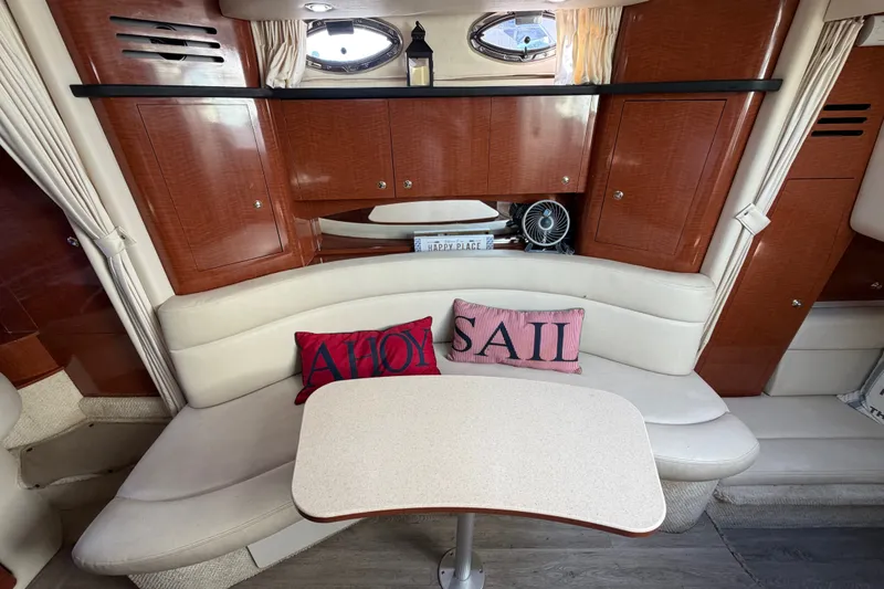 Slide: The Image of Interior of 2003 Sea Ray Sundancer 320 with cozy seating and nautical decor. - 24