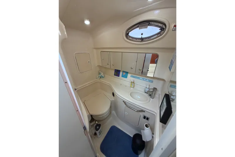 Slide: The Image of 2003 Sea Ray Sundancer 320 bathroom with sink, toilet, and storage cabinets. - 31