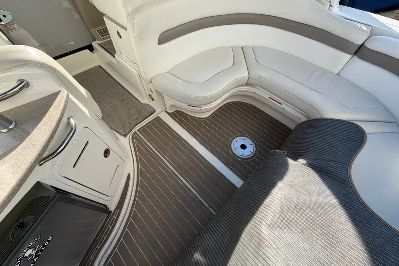 Slide: The Image of Interior of 2003 Sea Ray Sundancer 320 with white seating and wood-patterned flooring. - 9