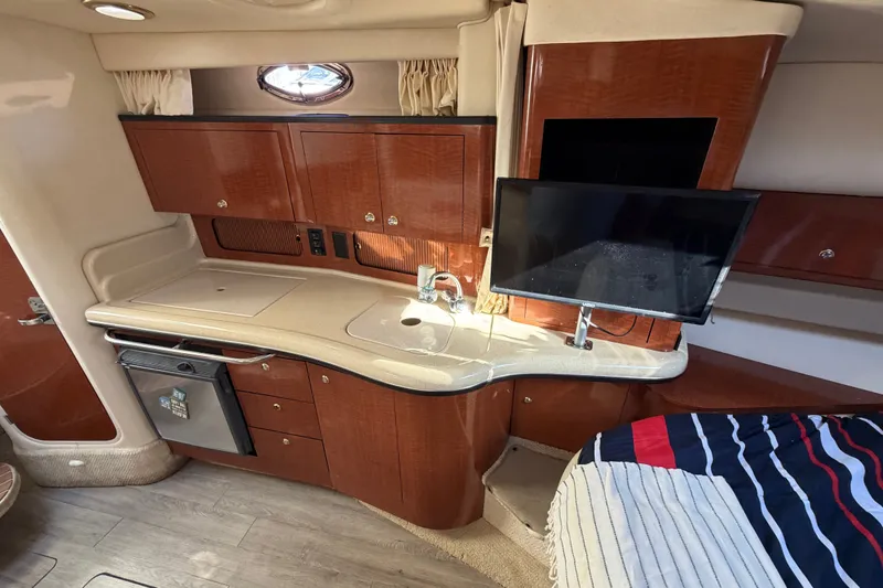 Slide: The Image of Interior of 2003 Sea Ray Sundancer 320 yacht with kitchenette and mounted TV. - 27