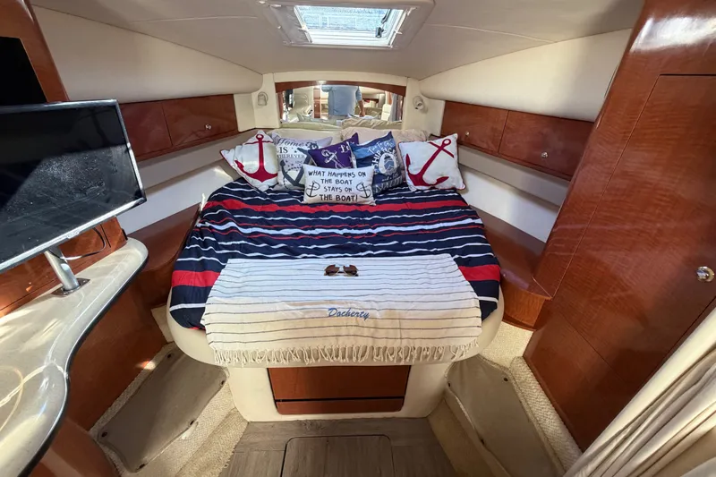Slide: The Image of Interior of 2003 Sea Ray Sundancer 320 with cozy bed and nautical decor. - 25
