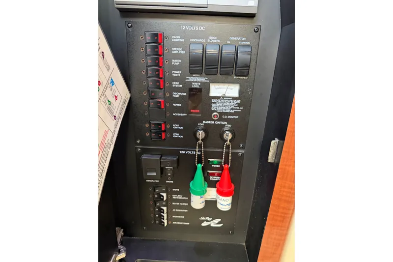 Slide: The Image of Control panel of a 2003 Sea Ray Sundancer 320 boat, featuring switches and ignition keys. - 19