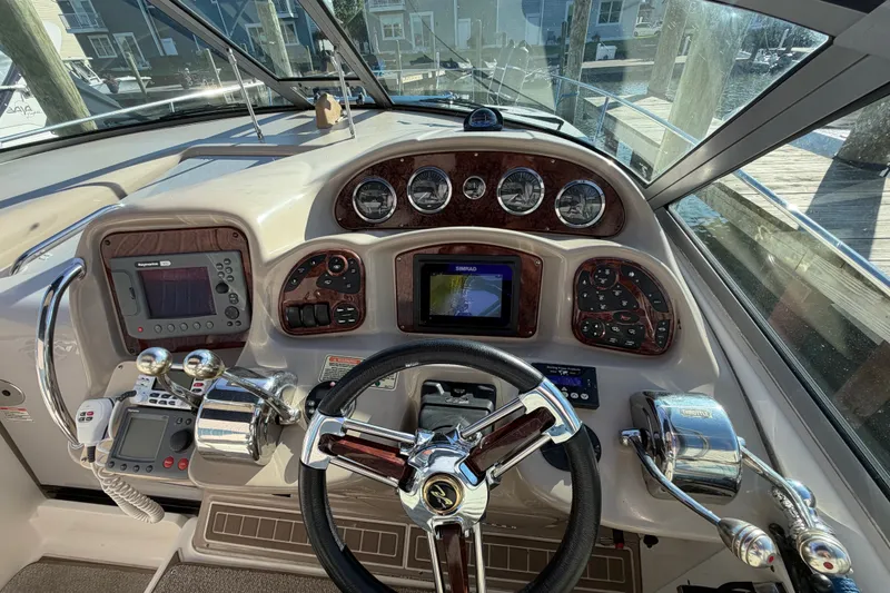 Slide: The Image of Helm of 2003 Sea Ray Sundancer 320 with navigation instruments and steering wheel. - 18