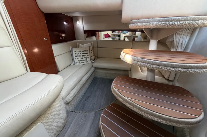 Slide: The Image of Interior of 2003 Sea Ray Sundancer 320 yacht with cozy seating and wooden steps. - 29