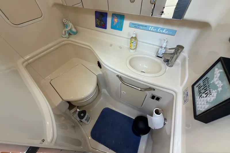 Slide: The Image of 2003 Sea Ray Sundancer 320 bathroom with toilet, sink, and nautical decor. - 32