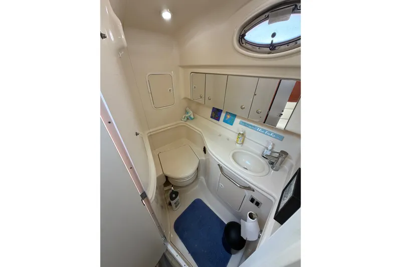 Slide: The Image of 2003 Sea Ray Sundancer 320 bathroom with sink, toilet, and storage cabinets. - 33