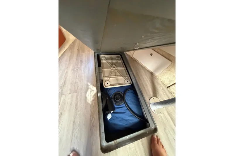 Slide: The Image of Storage compartment in a 2003 Sea Ray Sundancer 320 boat interior. - 34