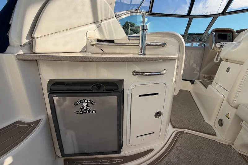Slide: The Image of Interior of a 2003 Sea Ray Sundancer 320 boat with kitchenette and seating area. - 8