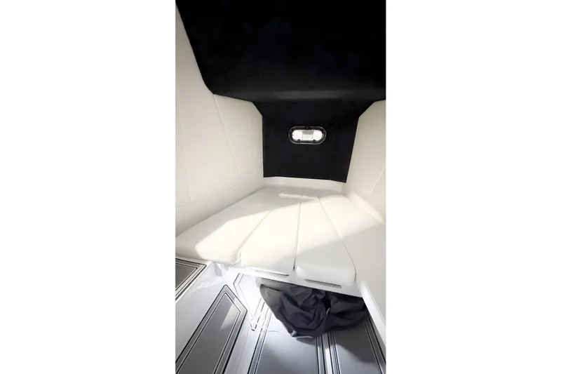 Slide: The Image of Interior cabin of 2022 Sunsation 32 CCX boat with white seating and small window. - 18
