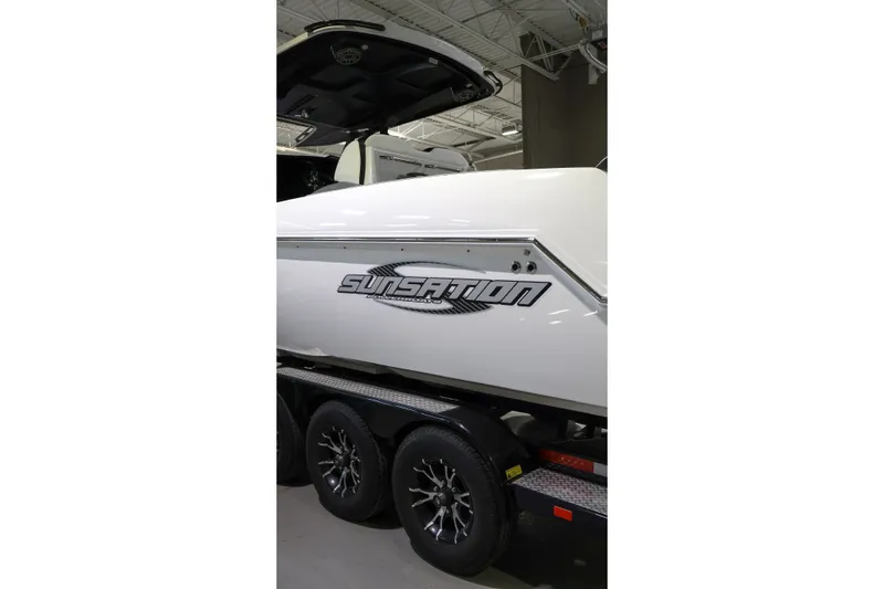 Slide: The Image of 2022 Sunsation 32 CCX boat on trailer in showroom. - 3