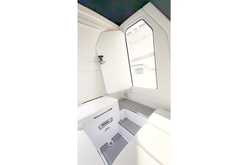 Slide: The Image of Interior cabin of 2022 Sunsation 32 CCX boat, featuring sleek white design and seating. - 16