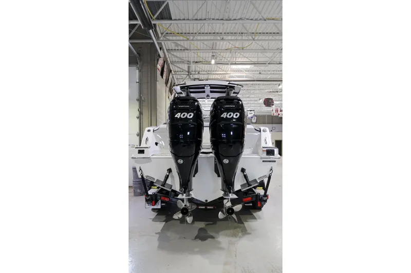 Slide: The Image of 2022 Sunsation 32 CCX boat with dual 400 horsepower Mercury outboard engines in a showroom. - 4