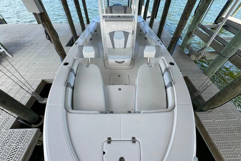 Slide: The Image of 2025 Robalo 226 Cayman boat docked, showcasing spacious interior and seating arrangement. - 16
