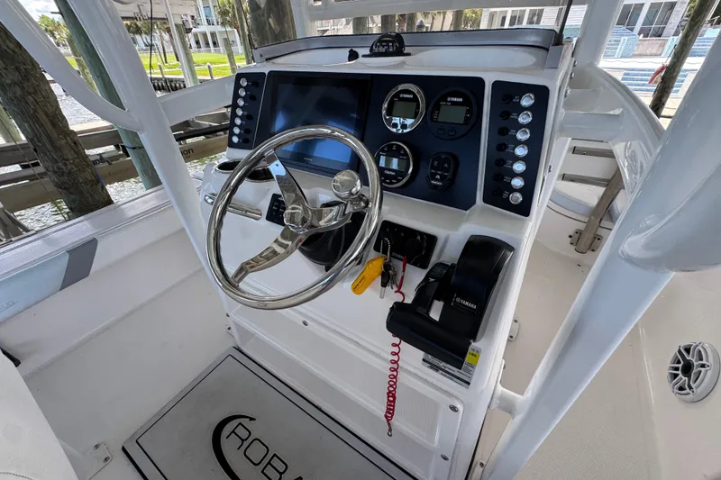 Slide: The Image of Helm of 2025 Robalo 226 Cayman boat with modern controls and steering wheel. - 29