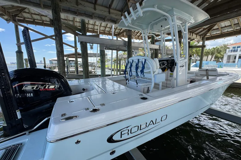 Slide: The Image of 2025 Robalo 226 Cayman boat docked, featuring Yamaha engine and sleek design. - 11