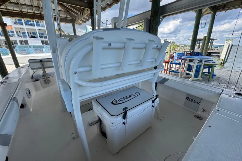 Slide: The Image of 2025 Robalo 226 Cayman boat interior with seating and storage, dockside view. - 30