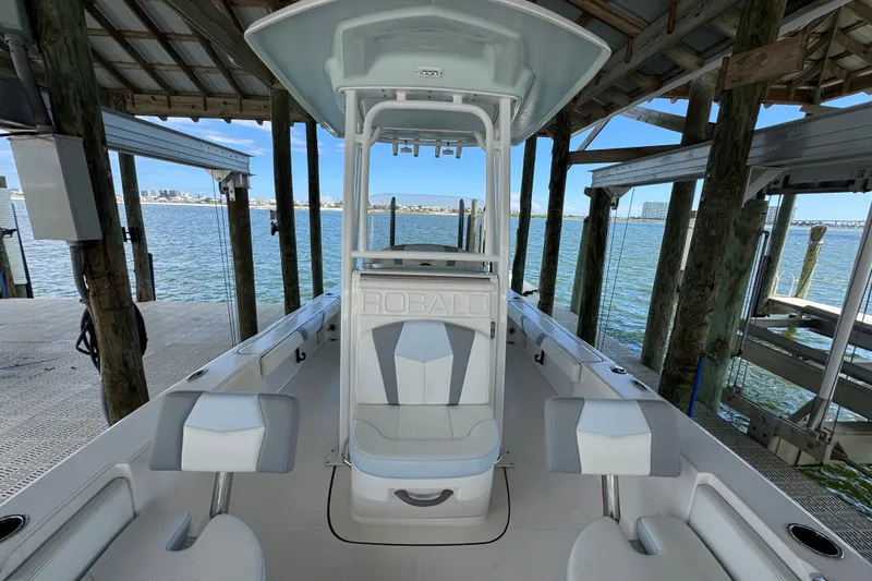 Slide: The Image of 2025 Robalo 226 Cayman boat docked, showcasing sleek interior and waterfront view. - 18