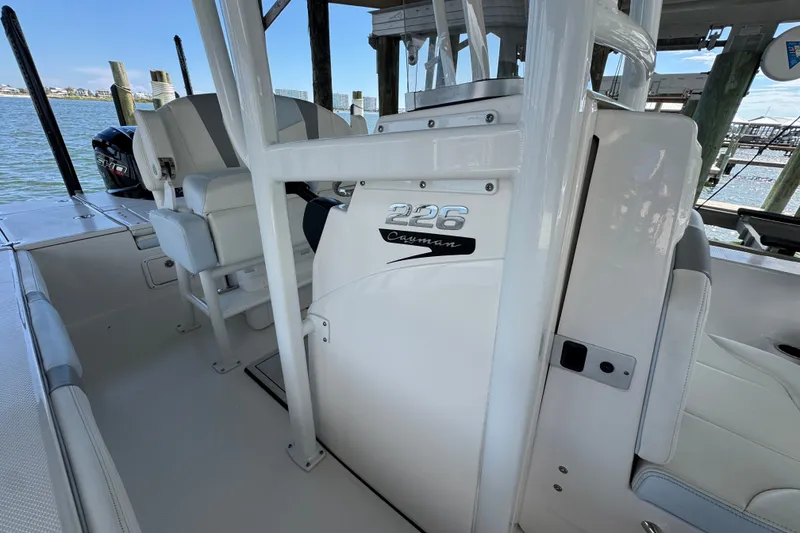 Slide: The Image of 2025 Robalo 226 Cayman boat interior, featuring sleek white seating and console design. - 20