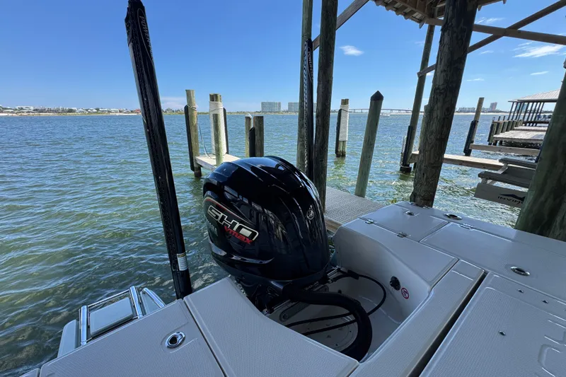 Slide: The Image of 2025 Robalo 226 Cayman boat docked by the water with Yamaha engine. - 36