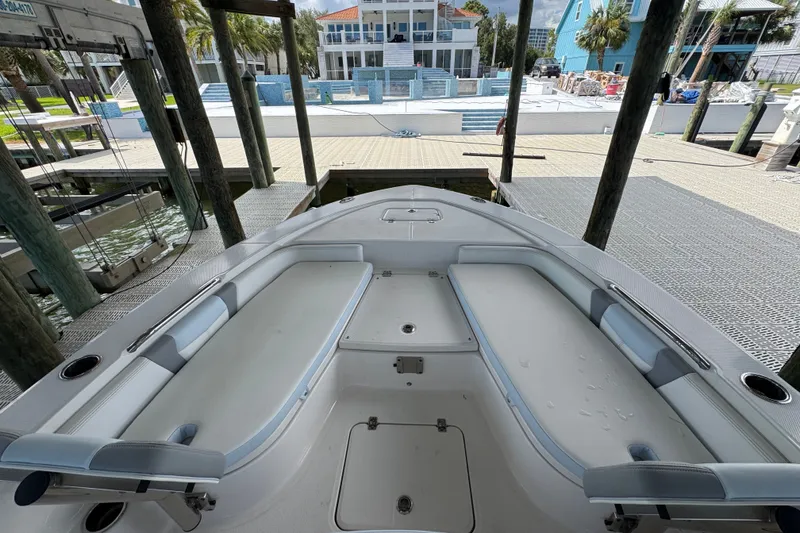Slide: The Image of 2025 Robalo 226 Cayman boat interior with spacious seating at dock. - 14