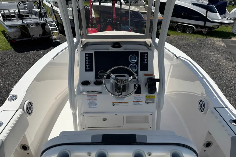 Slide: The Image of 2024 Robalo R180 Center Console boat interior with steering wheel and control panel. - 8