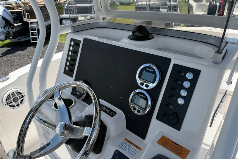 Slide: The Image of 2024 Robalo R180 Center Console dashboard with steering wheel and control panel. - 9