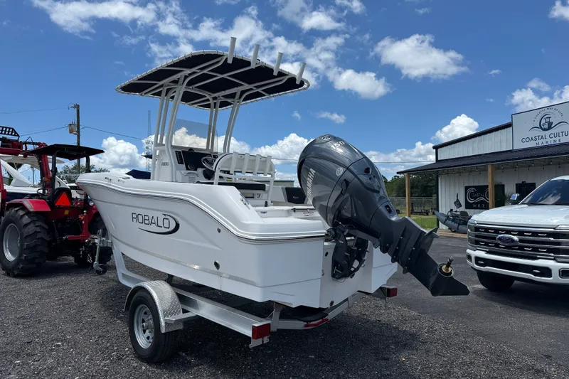 Slide: The Image of 2024 Robalo R180 Center Console boat with Yamaha outboard motor, parked outdoors. - 2