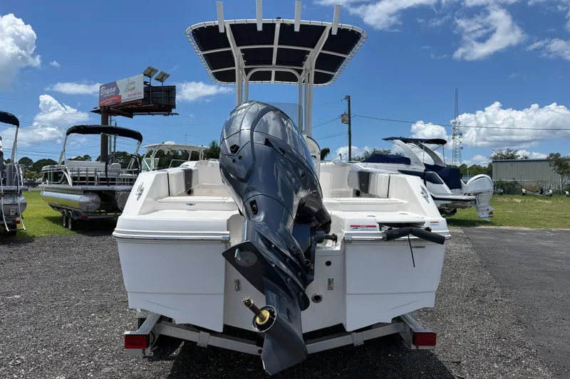 Slide: The Image of 2024 Robalo R180 Center Console boat with outboard motor, displayed outdoors under a clear sky. - 3