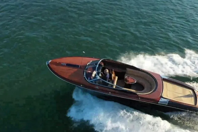 Slide: The Image of 2009 Riva 33' Aquariva luxury boat cruising on open water. - 2
