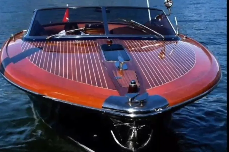 Slide: The Image of 2009 Riva 33' Aquariva luxury boat on water, showcasing sleek wooden deck design. - 8
