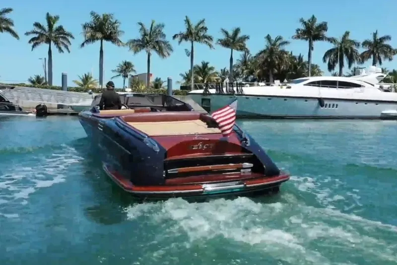 Slide: The Image of 2009 Riva 33' Aquariva boat cruising in tropical waters with palm trees in background. - 3