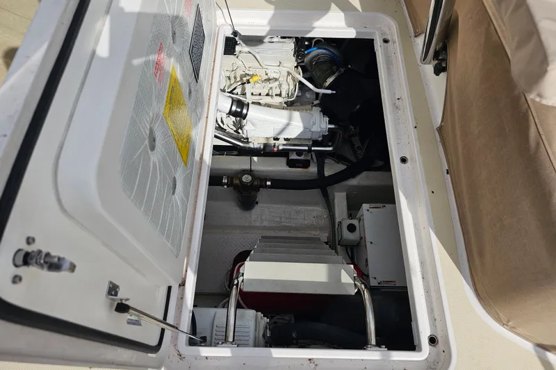 Slide: The Image of Engine compartment of a 2013 Sabre 48 Salon Express boat, showcasing mechanical components. - 57