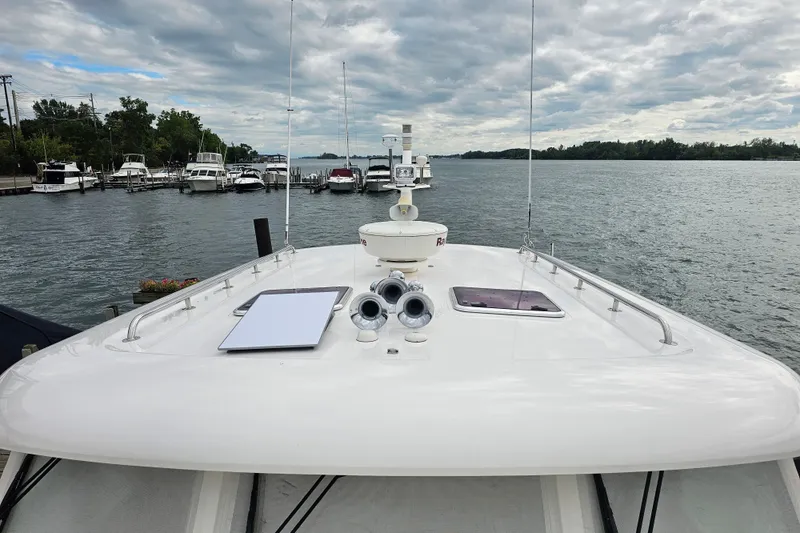 Slide: The Image of 2013 Sabre 48 Salon Express yacht docked at a marina under cloudy skies. - 3
