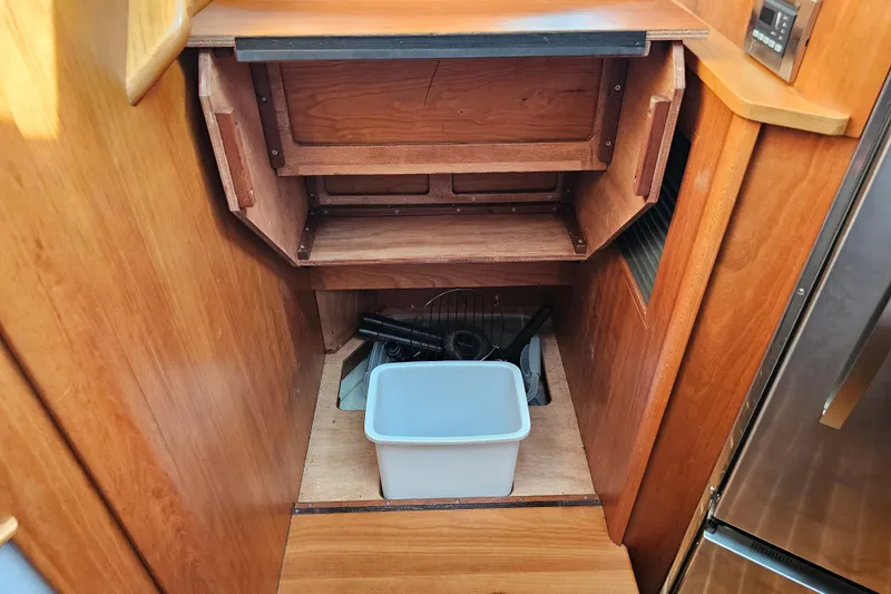 Slide: The Image of Interior storage area of a 2013 Sabre 48 Salon Express yacht with wooden cabinetry. - 30